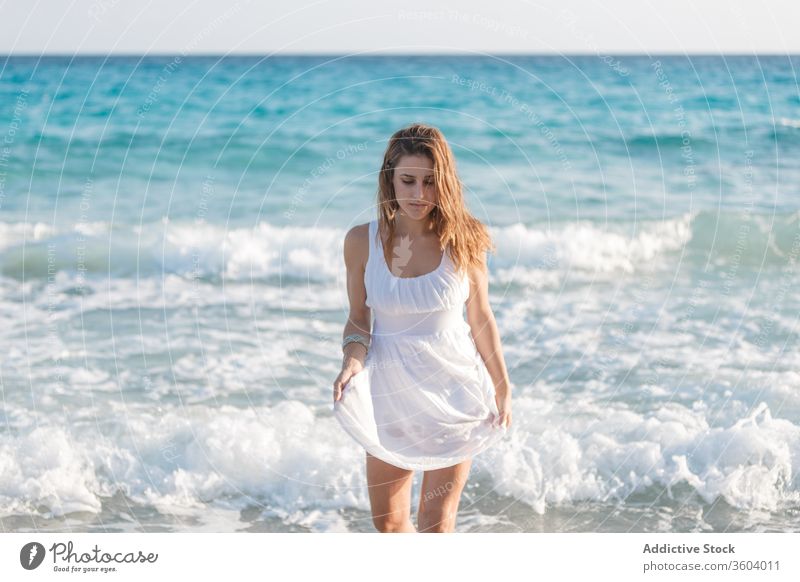 Tender woman in white dress at seashore in summer vacation tender beach seascape holiday enjoy female serene turquoise water sunny weather ocean relax tranquil