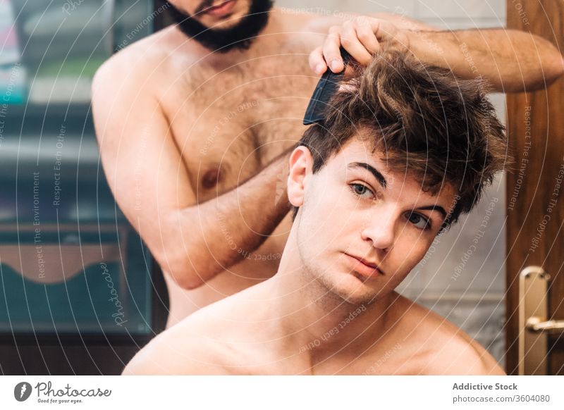 Barber doing hairstyle for male friend - a Royalty Free Stock Photo from  Photocase