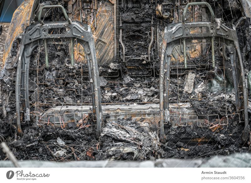 the frame of two car seats of a burnt-out car accident attack background berlin blaze broken burned burning city crime damage danger dangerous destroyed