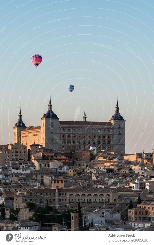 Cityscape with historic buildings and air balloons scenery cityscape sunset medieval architecture aged majestic old travel evening town cloudless sky scenic