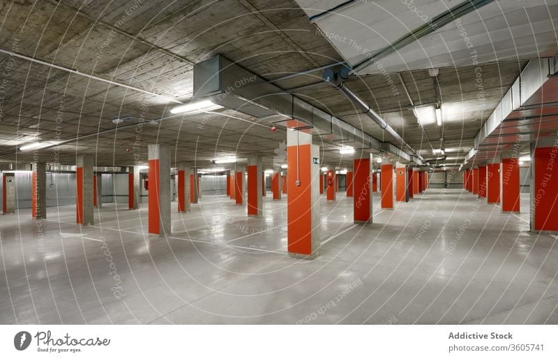 Spacious underground parking with numerated lots spacious concrete floor urban empty structure contemporary design construction cement wall public place modern