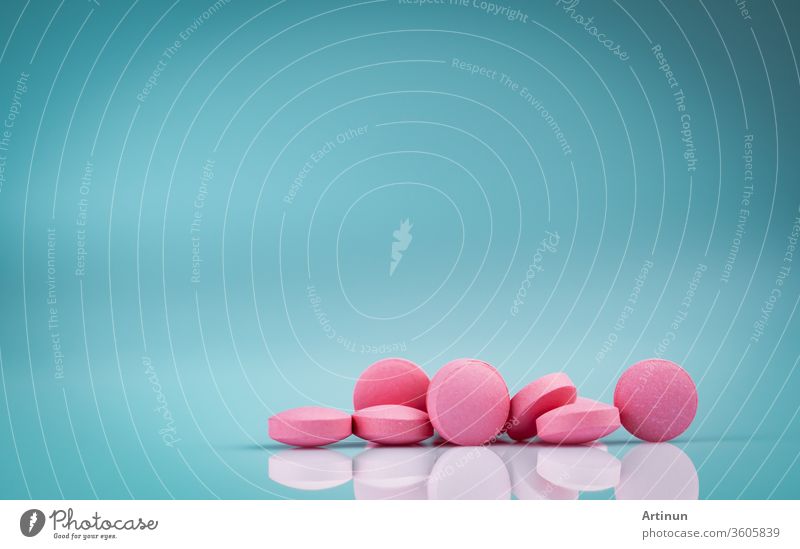 Pink round tablets pills with shadow on gradient background. Pharmaceutical industry. Pharmacy products. Vitamins and supplements. Medication use in hospital or drugstore. Global drug retail market.