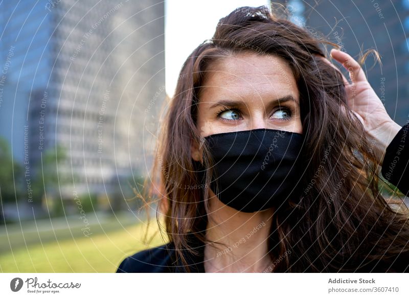 Serious woman in medical mask in city epidemic coronavirus covid 19 protect prevent safety female downtown serious modern respirator pandemic outbreak stand
