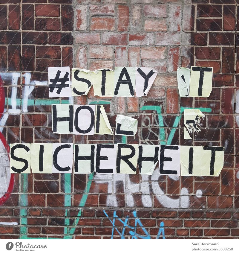 A detached writing on a brick wall Safety stay at home Berlin Corona virus Protection street art hash day