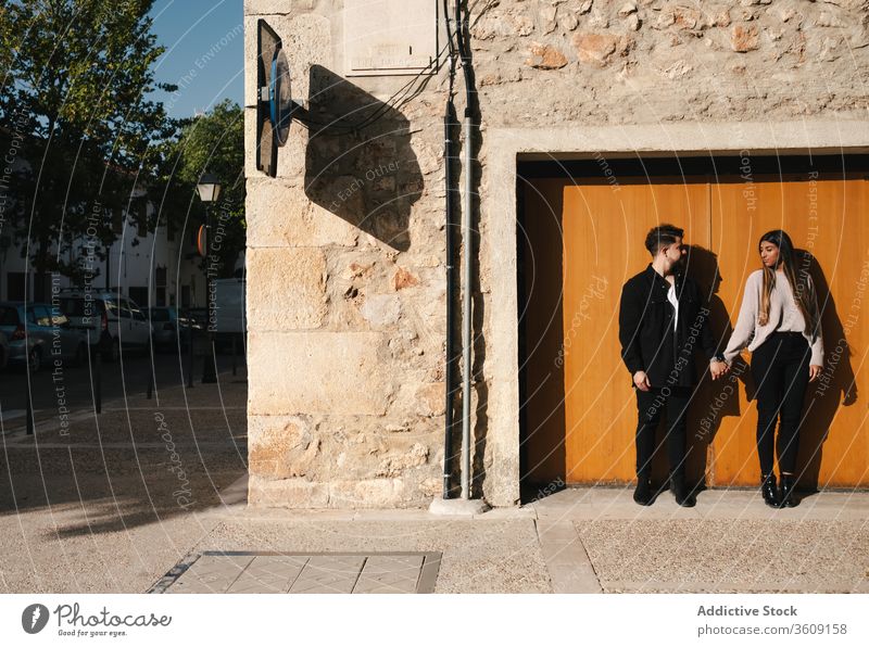Happy loving couple standing near door of old building love together happy young relationship romantic holding hands entrance weathered stone enjoy date romance