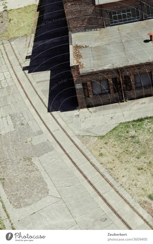 View of the rails of a factory railway from above with old factory buildings bows Railroad industrial railway Factory built Railroad tracks Industry Historic