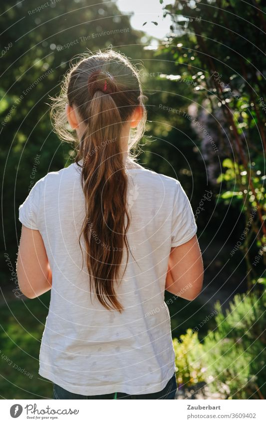 Girl with a ponytail in the golden back light looks into the garden girl Child Ponytail T-shirt White already pretty Sweet Garden Back-light Infancy Summer