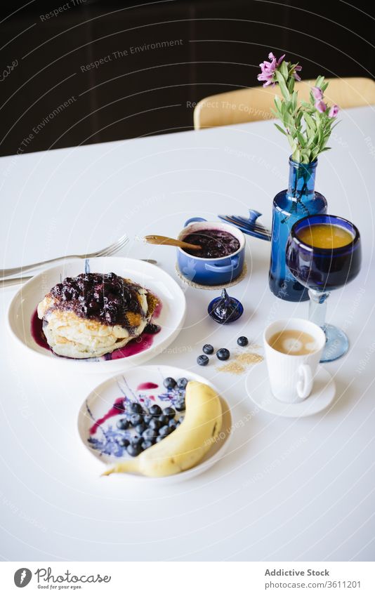 Table setting for healthy breakfast brunch table pancake berry fruit jam food tasty blueberry delicious homemade cup coffee banana fresh cozy kitchen morning