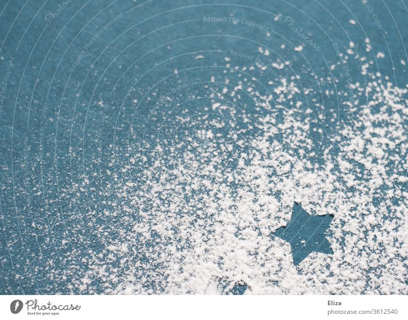 Star of icing sugar on a blue background Stars Christmas Snow Winter White Confectioner`s sugar Blue chill Decoration