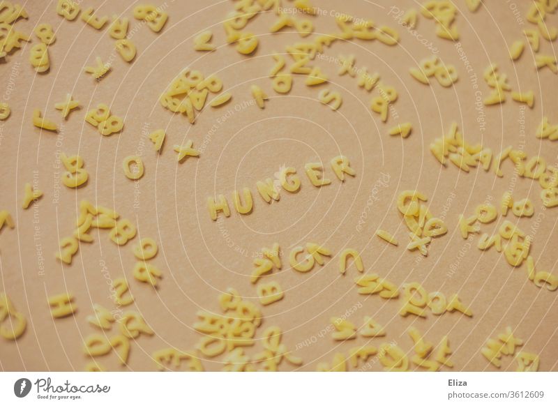 The word hunger from alphabet noodles Noodles world hunger Eating food products Food Appetite Lunch Dinner Alphabet noodles Nutrition Carbohydrates pasta gluten