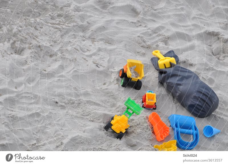 Toy cars and plastic toys on the sandy beach Beach Sandy beach Bird's-eye view lorry Truck Playing Summer Sandpit Rake moulds Sand toys play in sand vacation