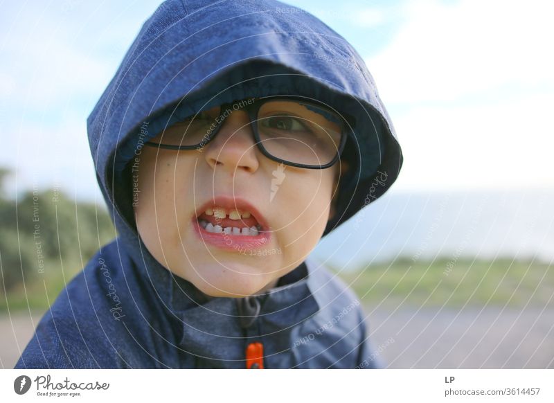 angry little boy Teeth showing Set of teeth Dentist Bite Close-up Dental care Dentistry Dangerous upset Fight Animosity Hooded (clothing) glasses Looking