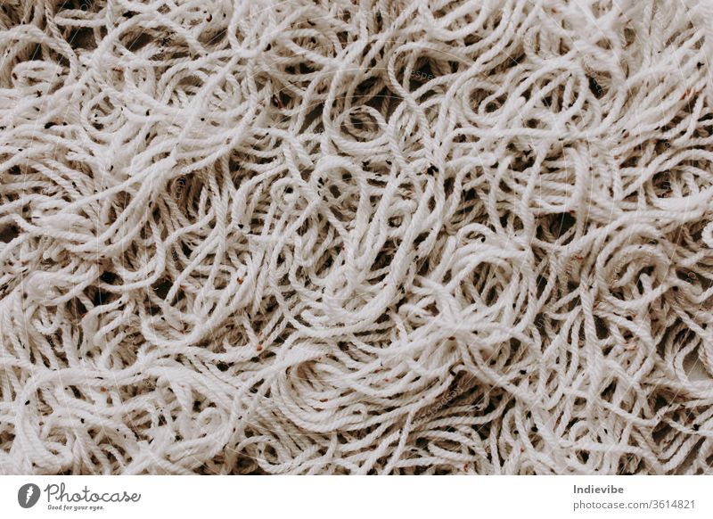 Tangled macrame cord heap on grey background hobby diy cut rope activity break closeup concept craft creative design divide eco friendly endless flat lay