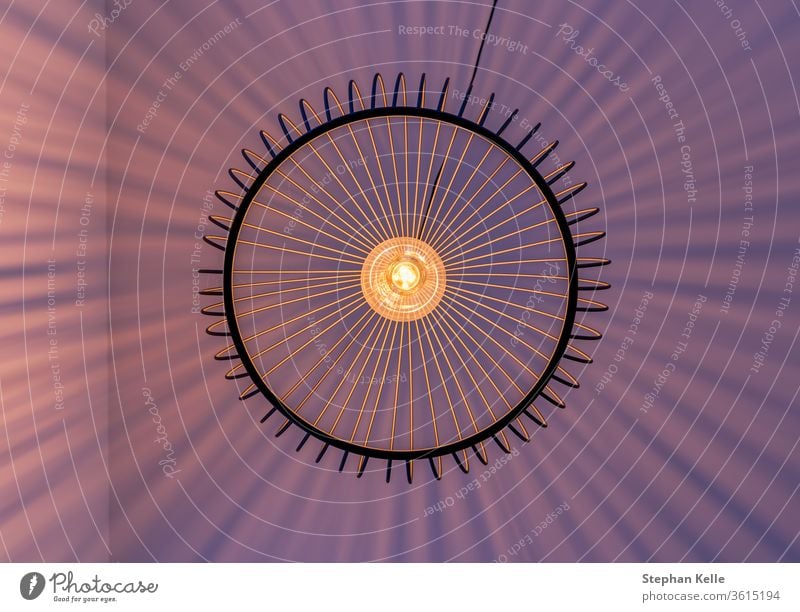 Geometric arranged light rays of a lamp excactly photographed vertical from below. wall striped abstract modern natural overshadow pattern photo effect