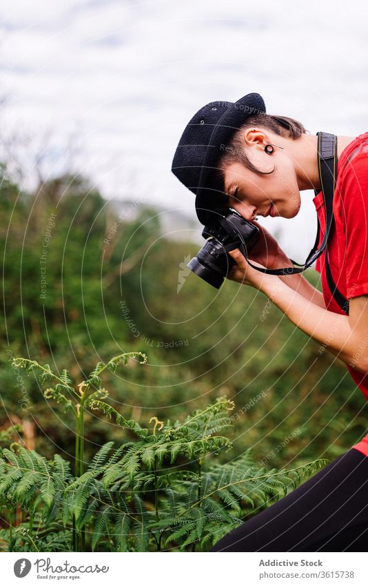 Female photographer taking picture of fern plant field woman nature style androgynous take photo photography photo camera female asturias spain creative skill
