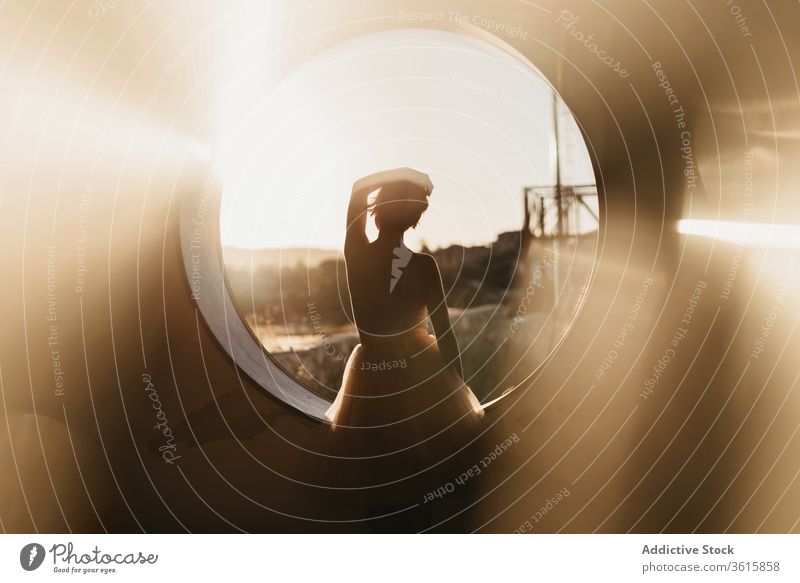 Relaxed female dancer looking at round hole woman grace relax silhouette dream pensive serene art creative window nature elegant slim sensual tranquil rest calm