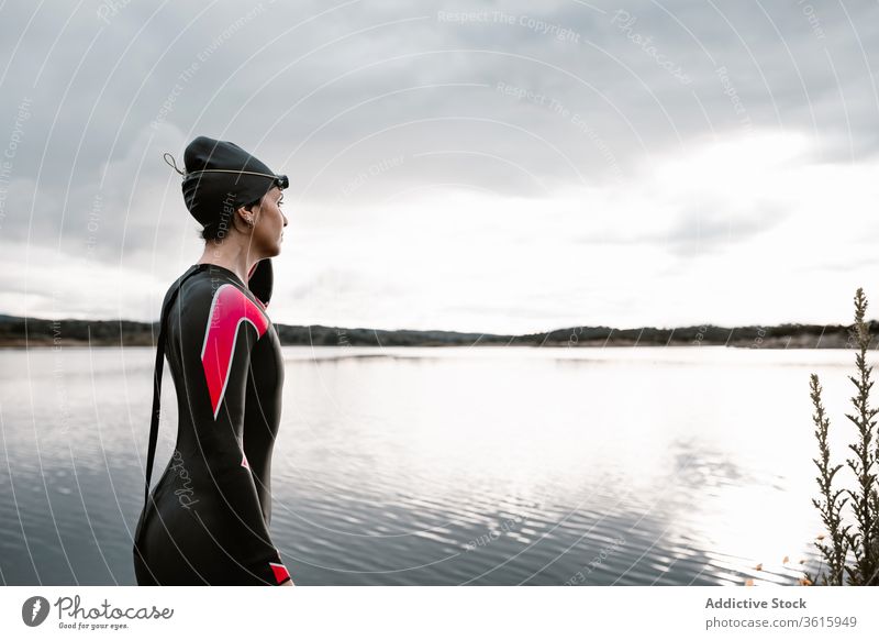 Woman in wetsuit wearing glasses on lake of shore woman diver goggles swimsuit extreme environment swimmer aqua sporty travel determine sportswoman vitality
