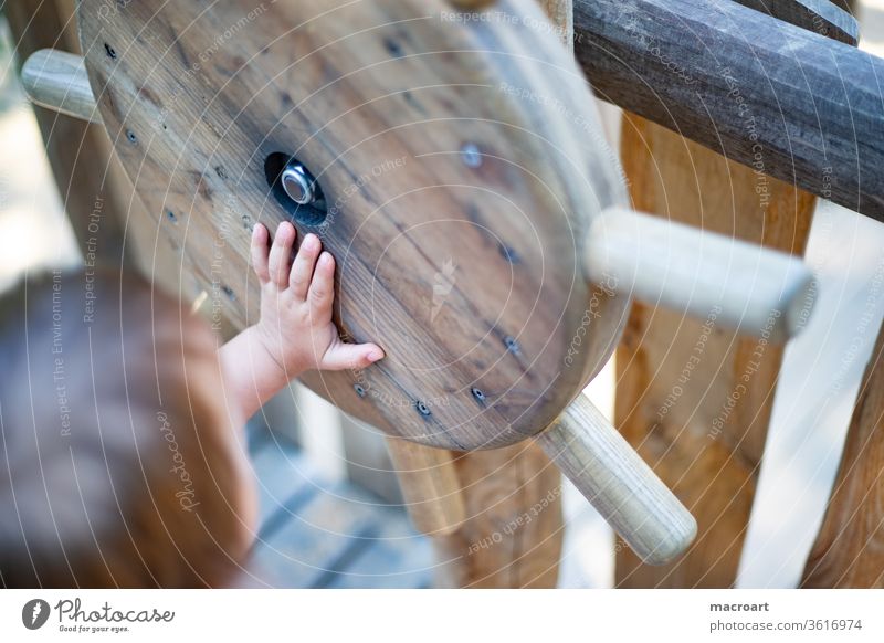 Conquer the world knd Playing Playground ship wooden playground Discover boat trip tax Steering wheel Romp by hand Close-up Detail Fingers Toddler Small Infancy