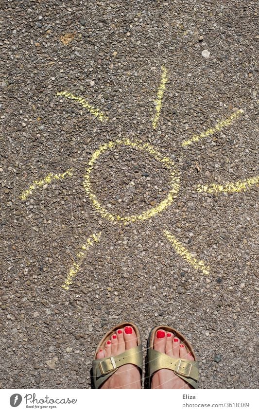 Female feet in Birkenstocks stand in front of a painted sun made of chalk on the street. Summer. Sun sunshine somerwise Sandals feminine Woman painted toenails