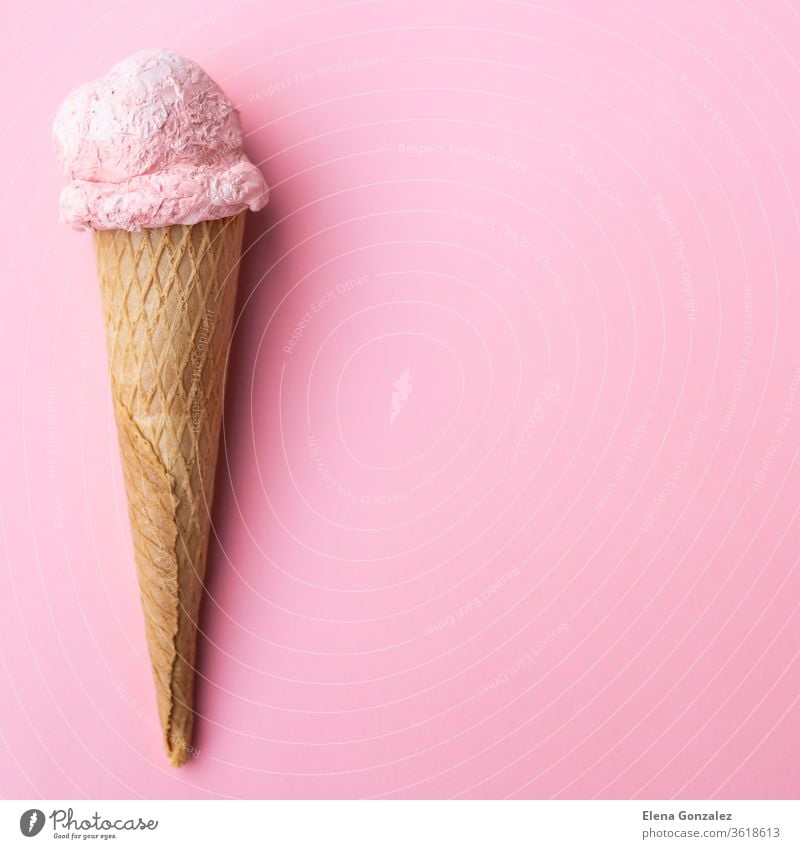 Close up strawberry ice cream in waffles cone on pink background. Copy space. product copy space backgrounds refreshing flavors conceptual rose advertising