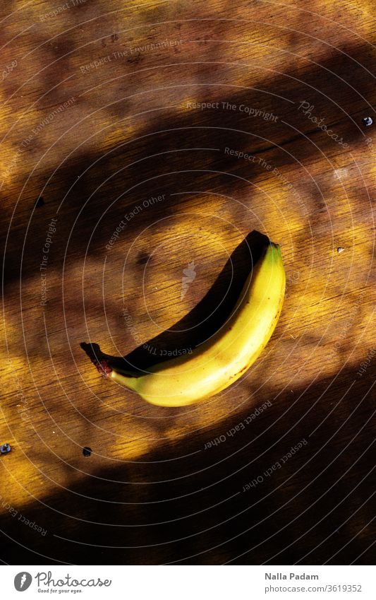 Banana lolling in the shade of a grate - Lost Banana in Folkestone Yellow Shadow Grating Analogue photo Warped Exterior shot Fruit Day Colour photo Nutrition