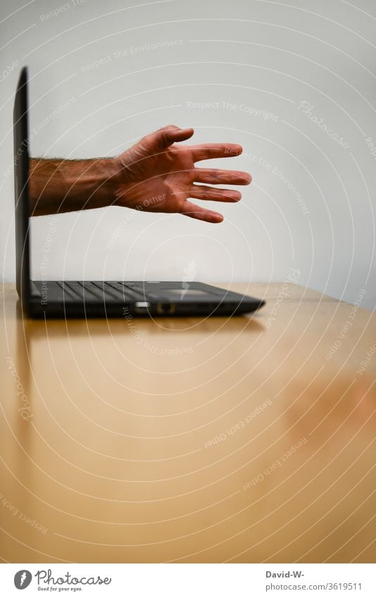 Hand breaks through the screen Screen break through laptop Addiction Intrusive Computer Online reality Virtual Internet Technology