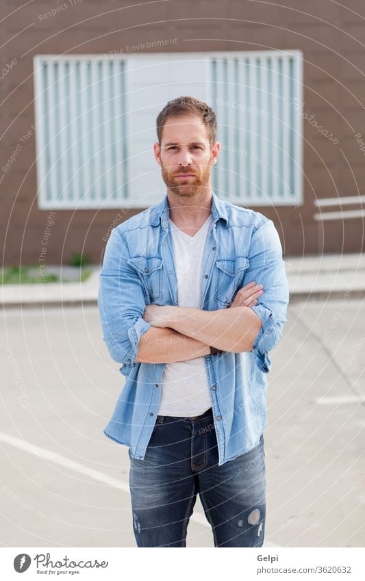 Casual guy with a denim shirt relaxed male young handsome casual man model beard fashion portrait attractive people adult person building confident style street