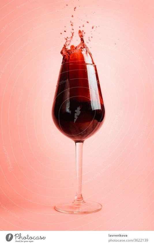 Red wine splash in a glass, dynamic picture, selective focus. liquor pouring droplet liquid winery red beverage drink celebration alcohol pink motion drops