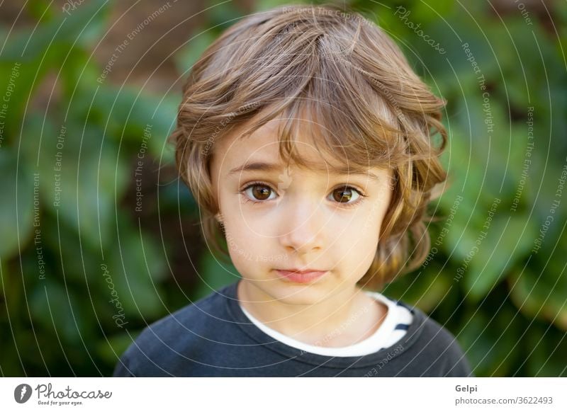 Portrait of a small child in the field kid outside smile joy little happy portrait green boy caucasian childhood cheerful nature spring outdoor baby tree funny