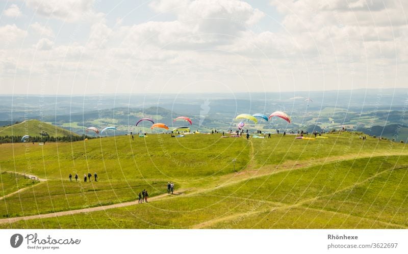 Colourful paragliders on the Wasserkuppe Exterior shot Day luck Smiley Flying Joy Aviation Cloudless sky Summer Freedom Far-off places Adventure Tourism