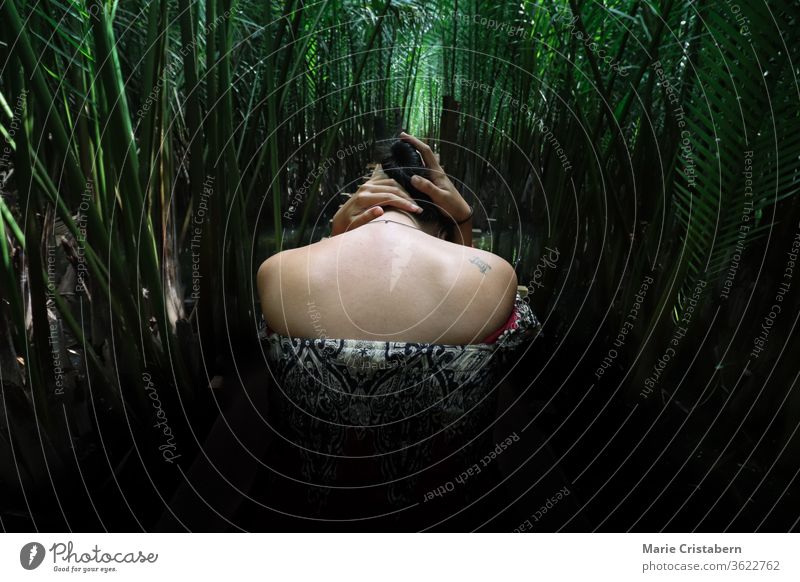 Conceptual portrait of a woman amidst dark foliage, showing the concept of depression and isolation dramatic portrait Woman darkness mental health Fear Concepts