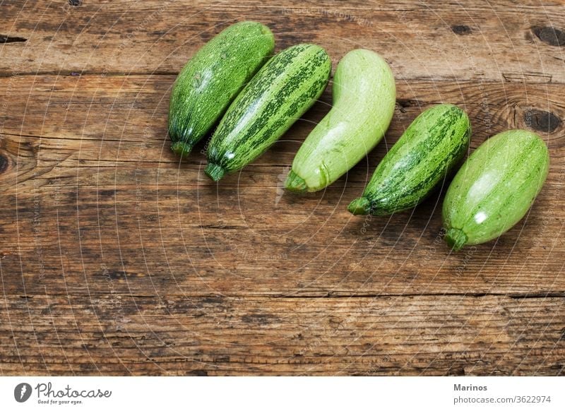 zucchinies on a wooden table background vegetable squash marrow design fresh green food healthy natural plant package group organic nutrition ingredient