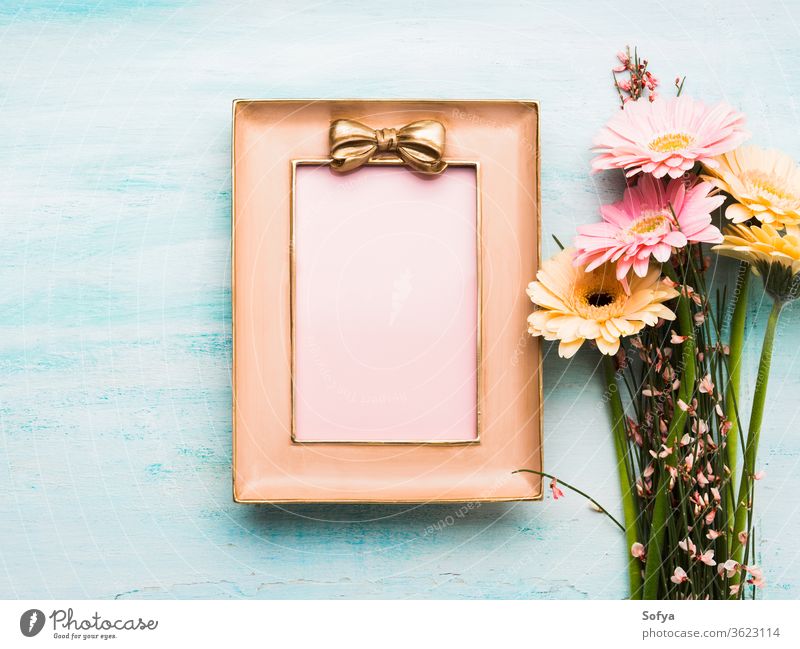 Beautiful flowers and pink frame on pastel green woman day card blank gift greeting floral flat lay spring holiday festive background invitation beautiful