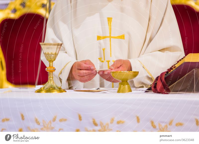 hands of Pope Francis with host and chalice with wine in the churches of the world papa altar missal book cup cross christianity gold sacred pyx goblet hosts