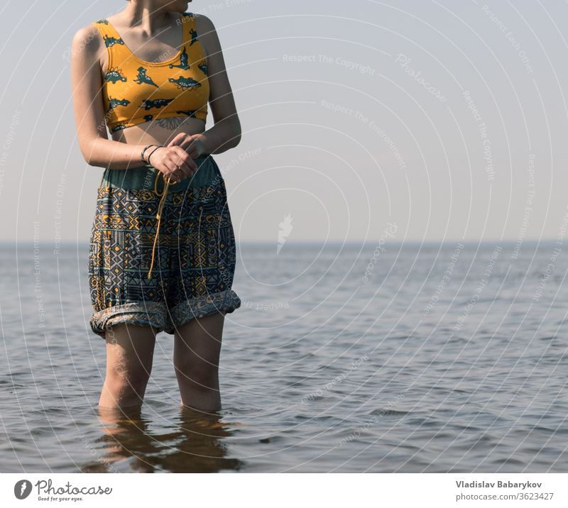 Young women with a tatoo stands in the water Girl Tattoo Water SEA seaside Lake