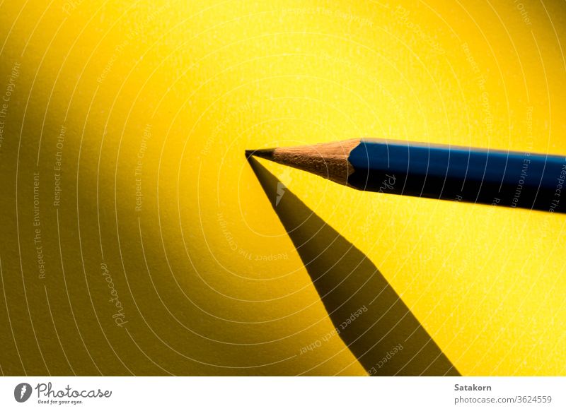 Pencil holding to write on the paper in shadow pencil drawing blank sketching detail art background action yellow