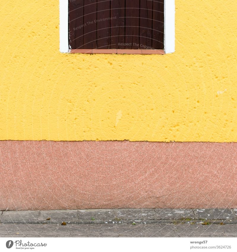 Colorful house wall painted with yellow paint and a partially depicted window. colourful Facade yellow color Window Building House (Residential Structure)