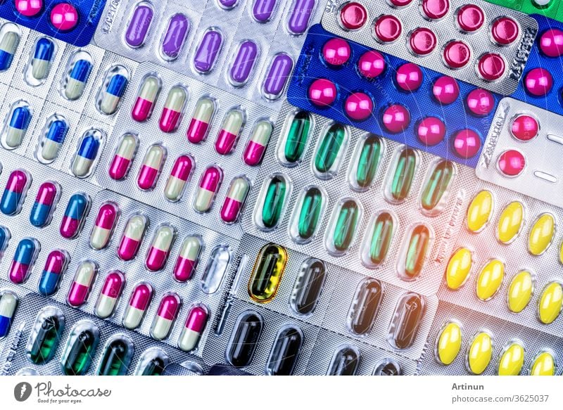 Colorful of tablets and capsules pill in blister packaging arranged with beautiful pattern with flare light. Pharmaceutical industry concept. Pharmacy drugstore. Antibiotic drug resistance. Defective.
