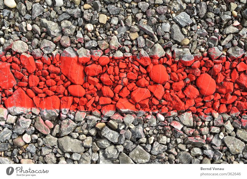 Stones in the red area Parking lot Signs and labeling Illuminate Lie Gray Red Gravel Boundary Border Line Colour Flashy Contrast Problem solving Temporary dyed