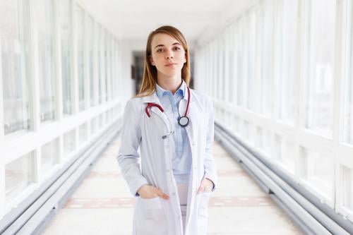 Portrait of a beautiful young female doctor with stethoscope in the clinic Healthy med youthful Woman Doctor Stethoscope Nurse medicine portrait Specialist girl