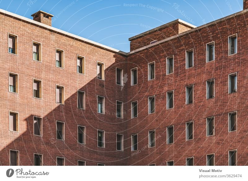 Symmetrical facades of an old brick building symmetrical structure abstract color urban exterior window repetition pattern row outdoors design architectural