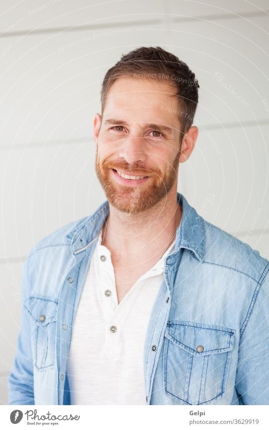 Portrait of a casual guy with denim shirt male young handsome man model beard fashion portrait attractive people adult person confident style jeans modern face