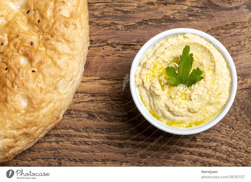 Arabian humus spread with bread Hummus Bread Flat bread Spread Sesame Chickpeas overhead boil Greek Delicious Vegetable Fresh Appetizer salubriously background