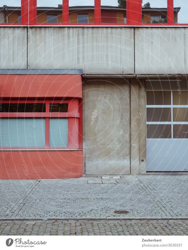 Detail of the facade of a fire brigade building in Berlin Neukölln in red and grey Facade Fire department Red Gray Concrete Wall (building) Street pavement Goal