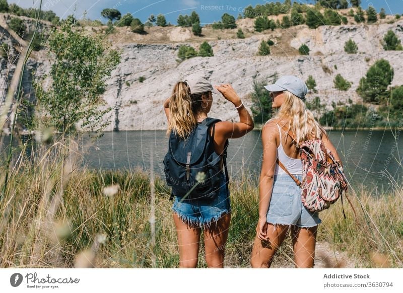 Best female friends near lake during holiday best friend carefree women girlfriend vacation admire landscape spectacular grass shorts stand sunny relax freedom