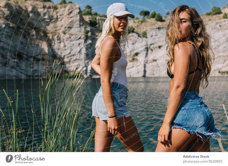 Best female friends near lake during holiday best friend carefree women girlfriend vacation admire landscape spectacular grass shorts stand sunny relax freedom