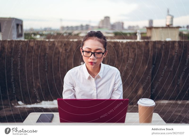 Busy woman with laptop working on rooftop using businesswoman formal device gadget glasses asian young female internet communicate browsing connection