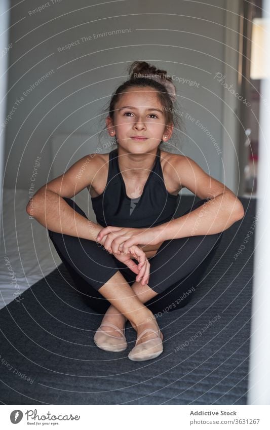 Teen girl in gymnastic sportswear sitting on bed dream teen home slim confident slender activity lifestyle pensive fit modern body contemplate thoughtful