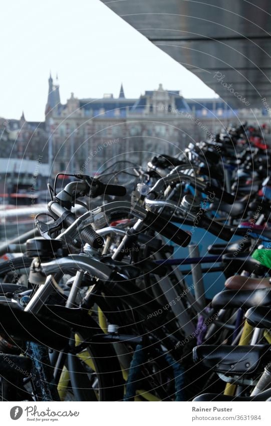 Bicycle parking lot in Amsterdam, Netherlands amsterdam background bicycle bicycles bike dutch europe holland netherlands parking space rows of bicycles station