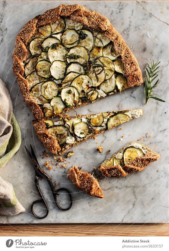 Zucchini galette on wooden table nutritionist tasty brunch feta cheese seasonal vegan cooking recipe healthy eating appetizers dining baked parchment paper